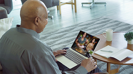 Person in virtual meeting on their laptop