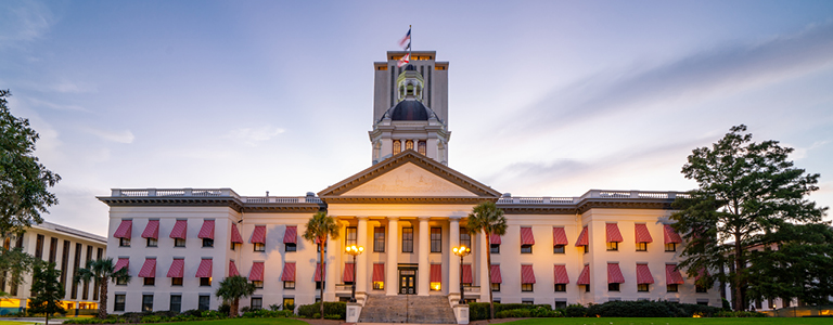 The Florida State Capitol illuminated at dusk.